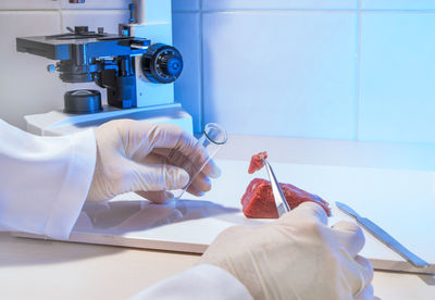 Cropped hands of scientist working in laboratory