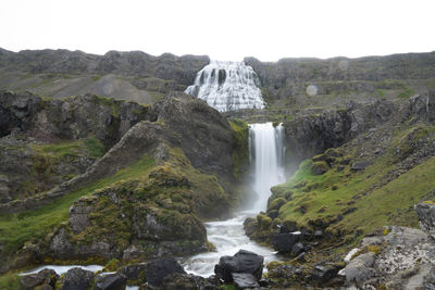 Scenic view of waterfall against sky