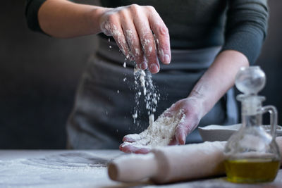 Woman baker with flour in her hands