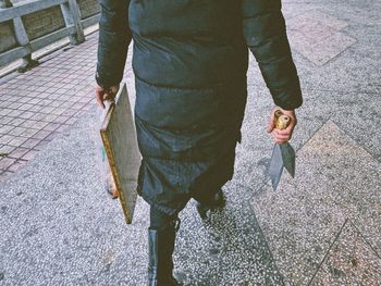 Low section of person standing on footpath