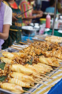 Midsection of person preparing food at market