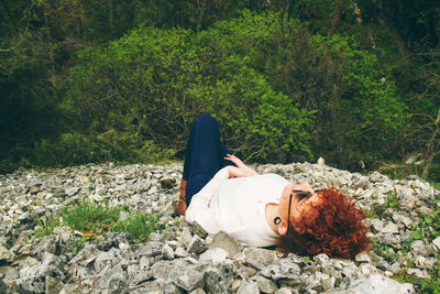 High angle view of woman relaxing on stones