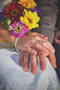 Cropped image of woman holding flower