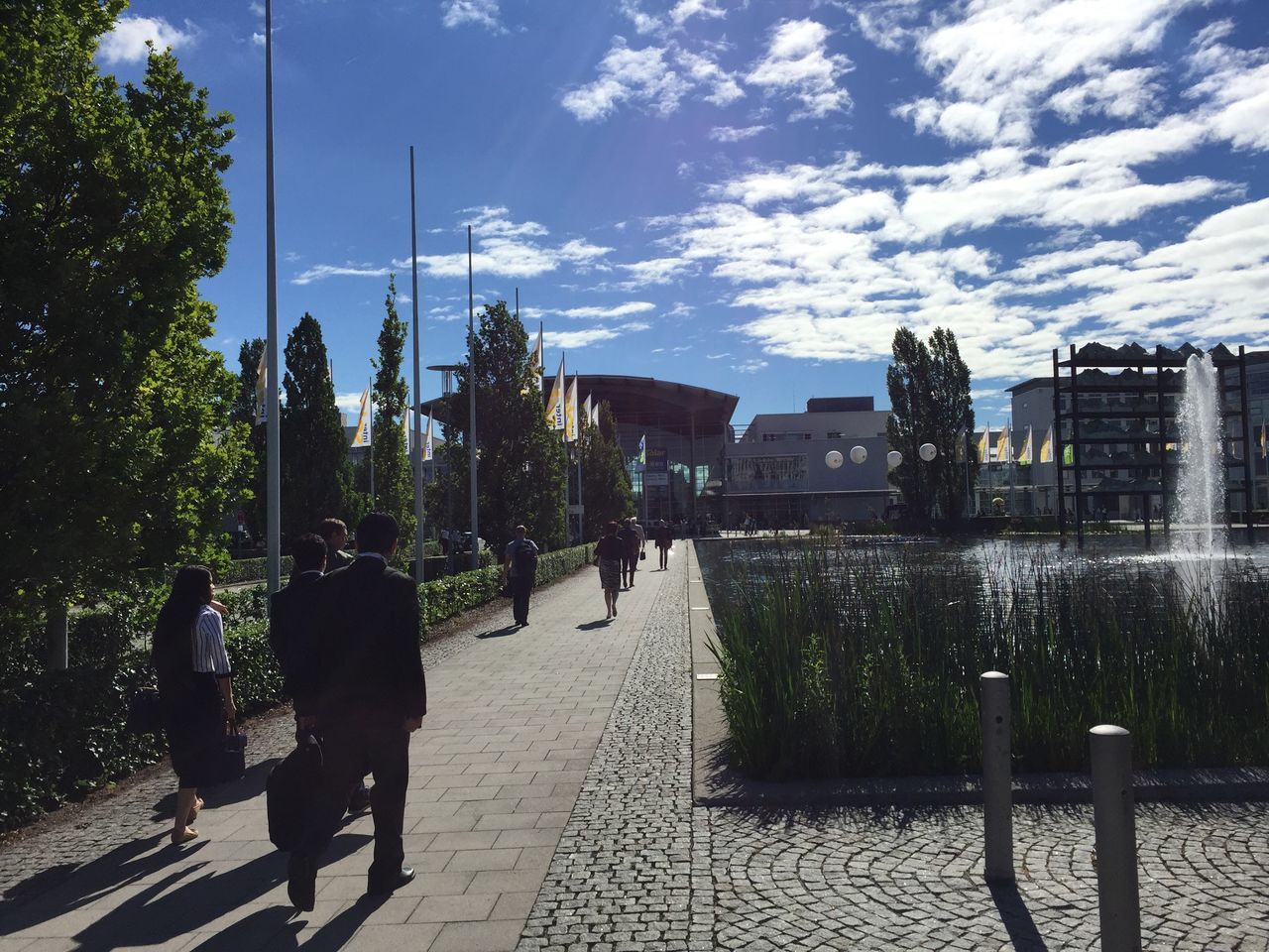 PEOPLE ON SIDEWALK IN CITY