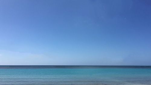 Scenic view of sea against blue sky