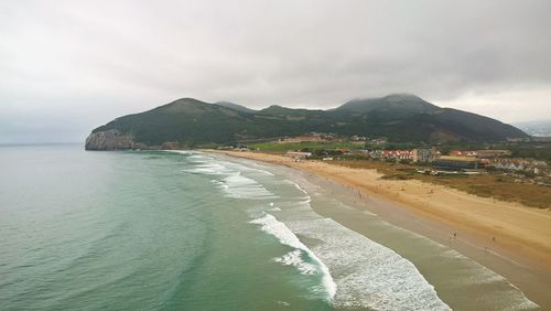 View of beach against cloudy sky