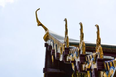 Low angle view of metallic roof against sky