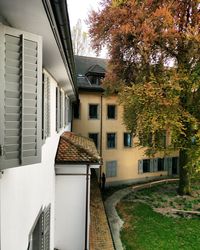 Houses amidst buildings in town against sky