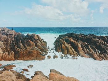 High angle view of rocky beach against the sky