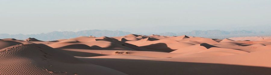 Panoramic view of desert against clear sky