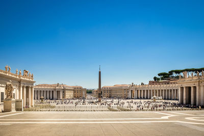 Historic building and obelisk at st peters square against clear blue sky