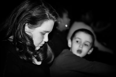 Side view of siblings in darkroom