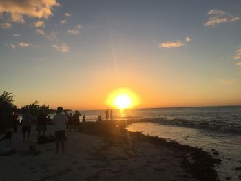 Scenic view of beach against sky during sunset