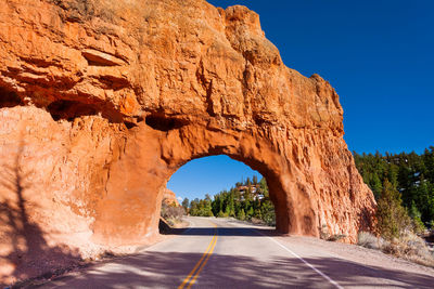 Road amidst rock formation against sky