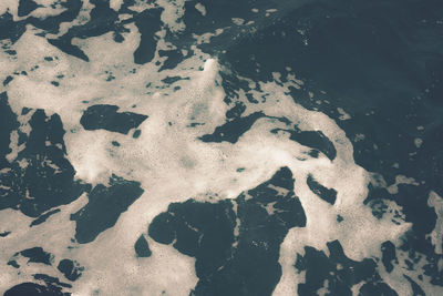High angle view of frozen water on land