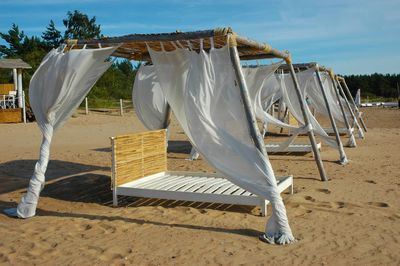 Clothes drying on beach against sky