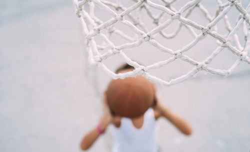 High angle view of boy playing basketball