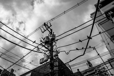 Low angle view of electricity pylon against sky