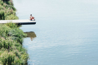 Man sitting by lake