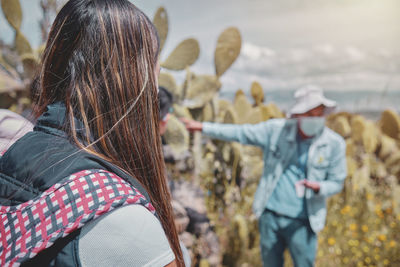 Group of tourists listening the guide explanation about wari archaeological complex, ayacucho. peru