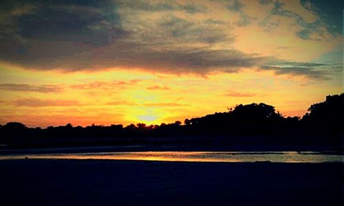 Scenic view of cloudy sky at sunset