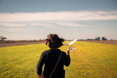 Rear view of woman walking on land