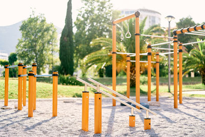 Close-up of metallic structure on table against trees