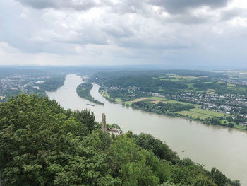 High angle view of river amidst cityscape against sky