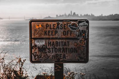 Close-up of information sign on beach