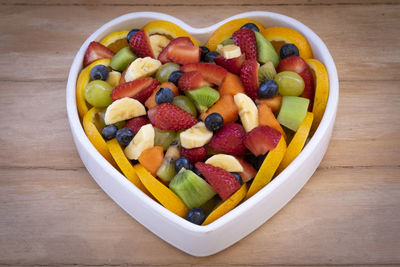 High angle view of chopped fruits in bowl on table