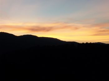 Silhouette mountain against sky during sunset