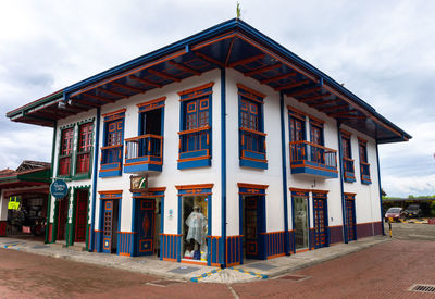 Exterior of house by building against sky