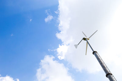 Low angle view of wind turbine against sky