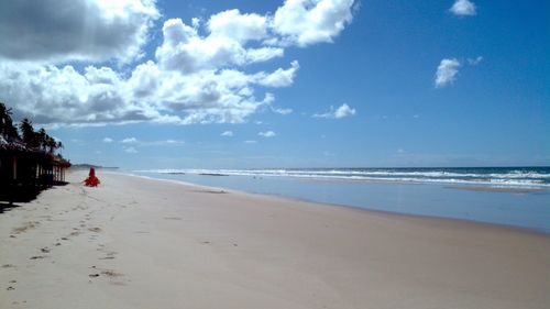 Scenic view of calm sea against cloudy sky