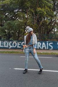 Full length of woman standing on road