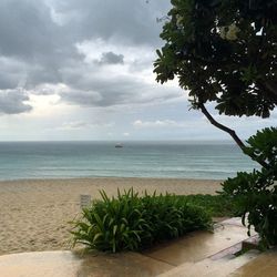 Scenic view of sea against cloudy sky