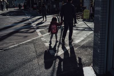 Low section of people walking on road