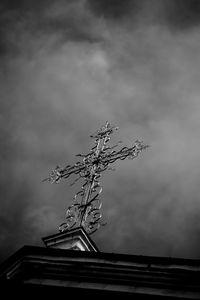 Low angle view of statue against building against sky