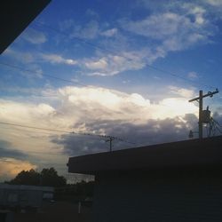 Low angle view of building against cloudy sky