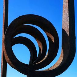 Low angle view of spiral staircase against clear blue sky