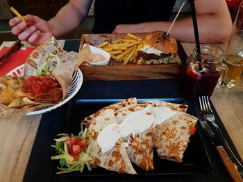 Close-up of hand holding food on table