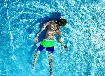 High angle view of boy swimming in pool