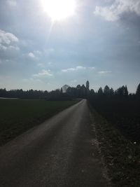 Road amidst trees against sky