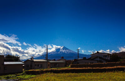 Houses and buildings against blue sky