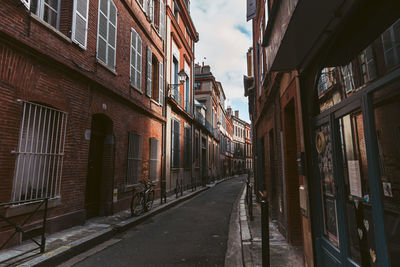 Street amidst buildings against sky