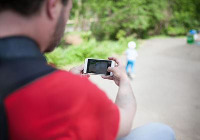 Close-up of man using mobile phone