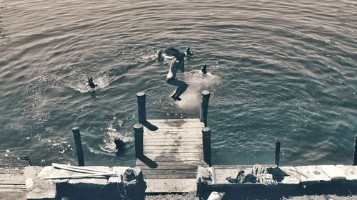 Full length of man jumping in lake