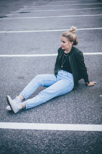 Woman sitting on road