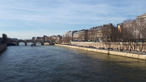 Bridge over river against buildings in city