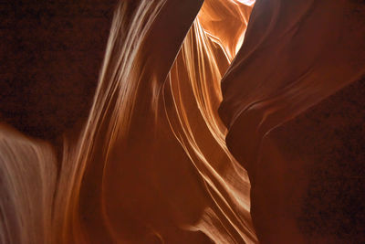 Low angle view of woman standing against orange wall